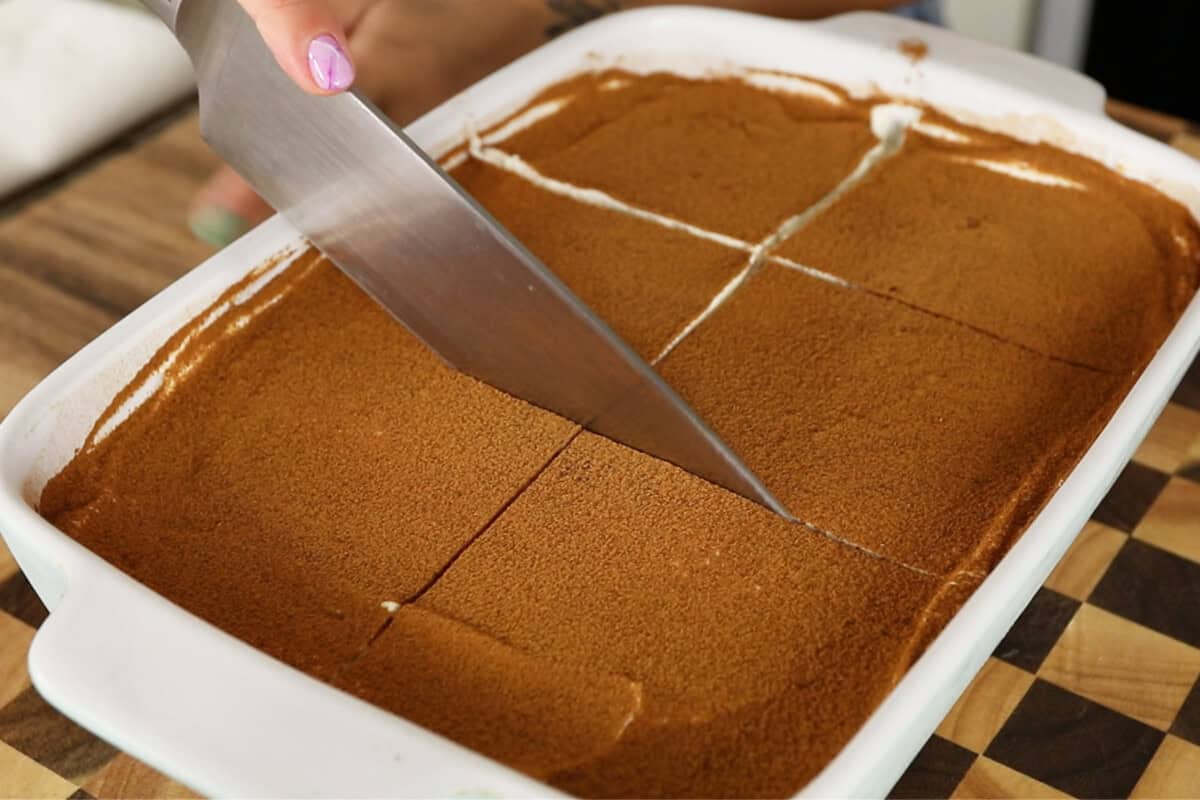 slicing the vegan masala chia tiramisu