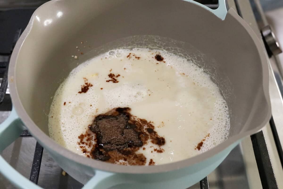 step by step: adding masala chai to the pot of milk