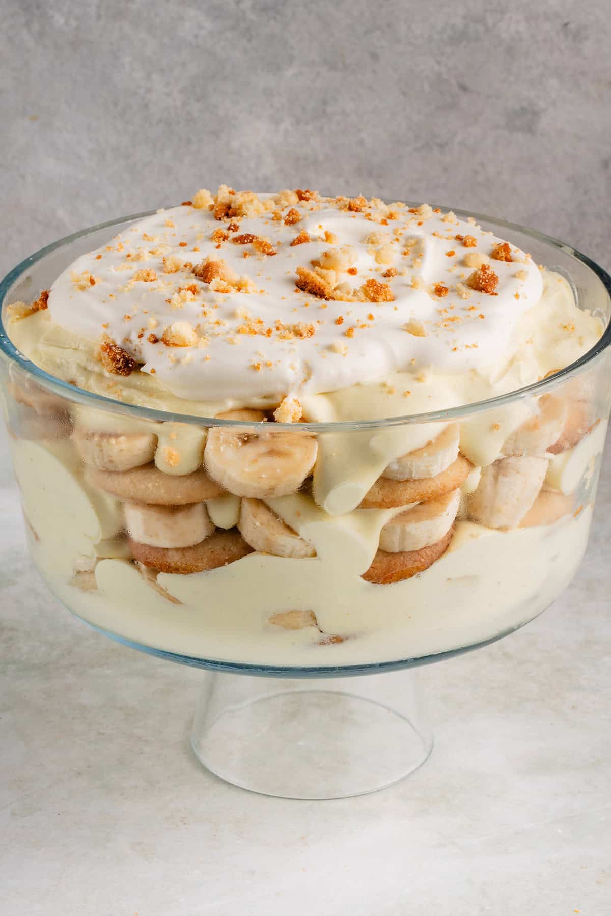 vegan banana pudding with whipped cream in clear trifle dish