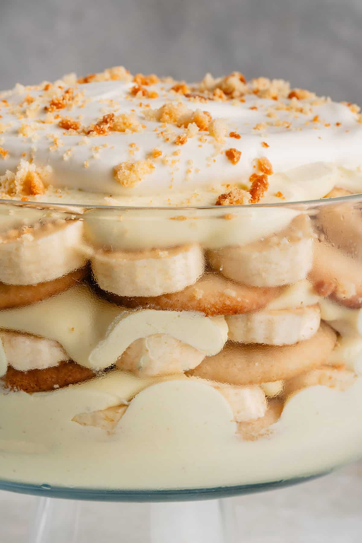 vegan banana pudding with whipped cream in clear trifle dish