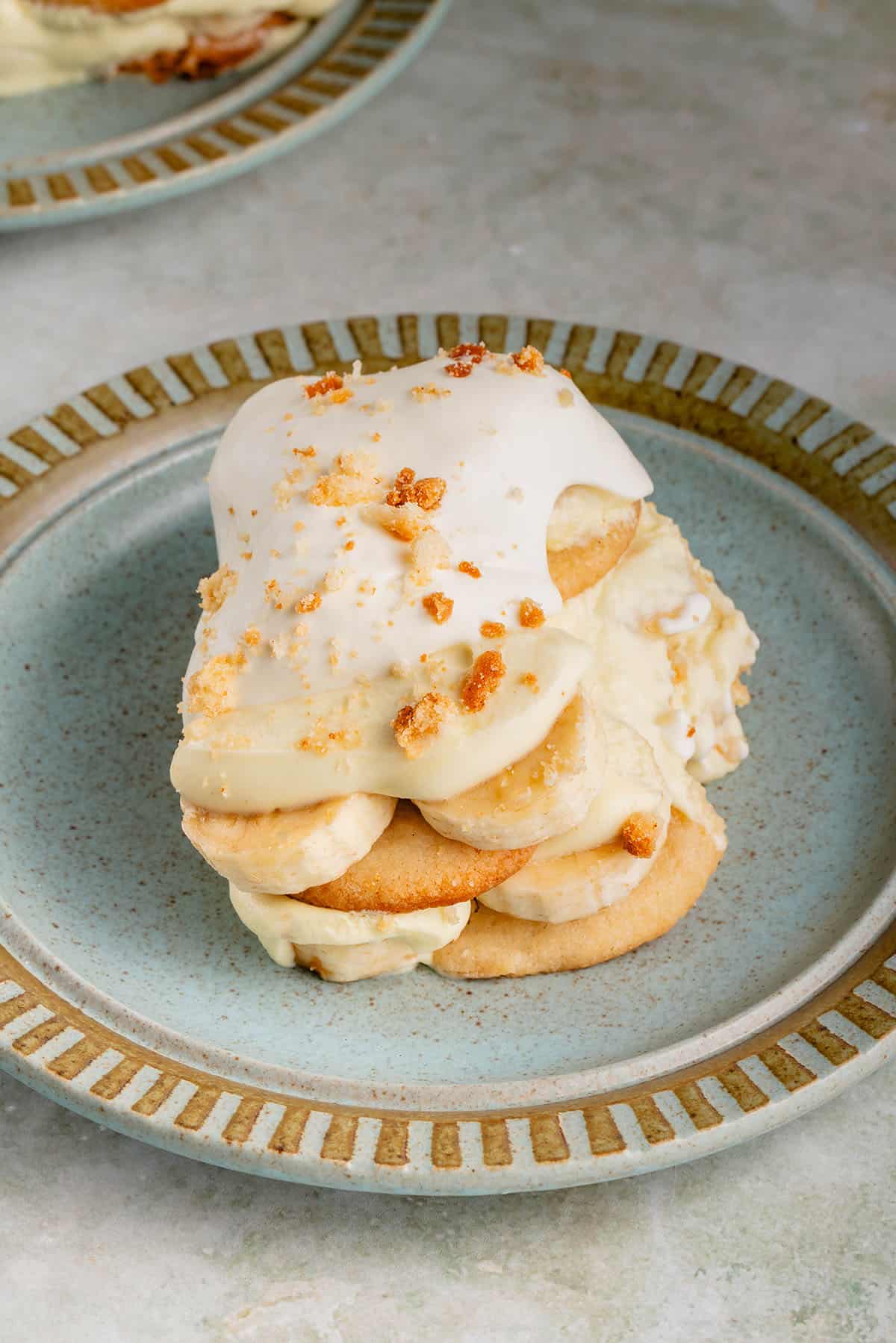 a serving of vegan banana pudding with whipped cream on blue plate