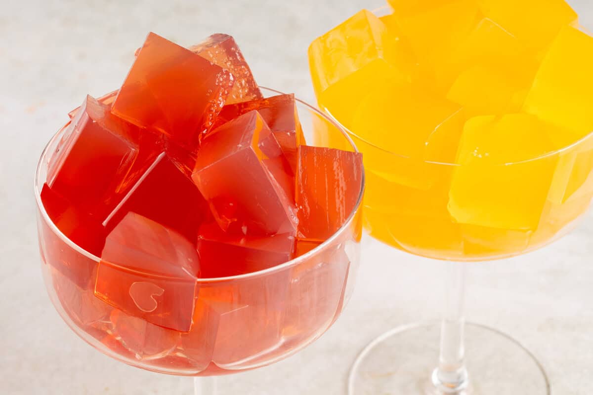 two tall glasses filled with vegan jello cubes