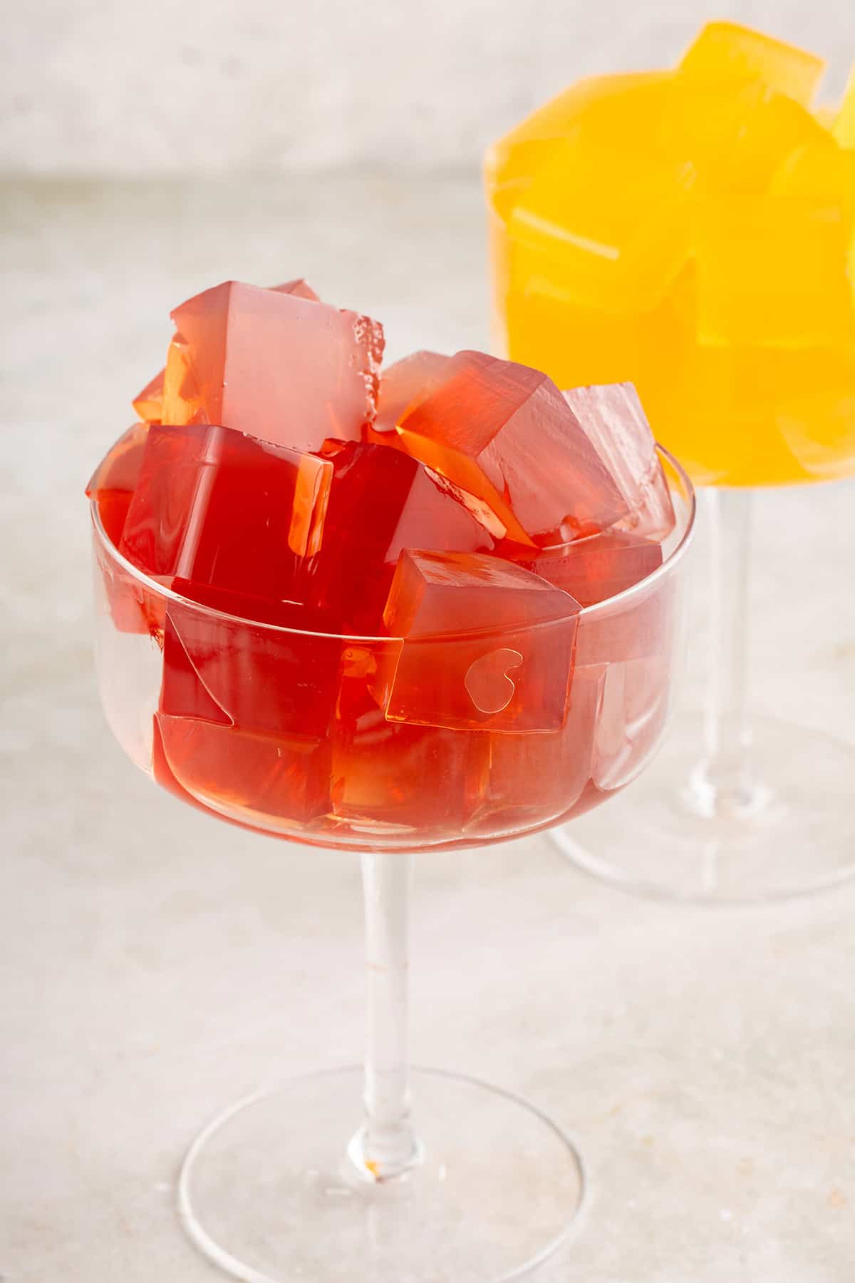 tall glass filled with vegan jello cubes