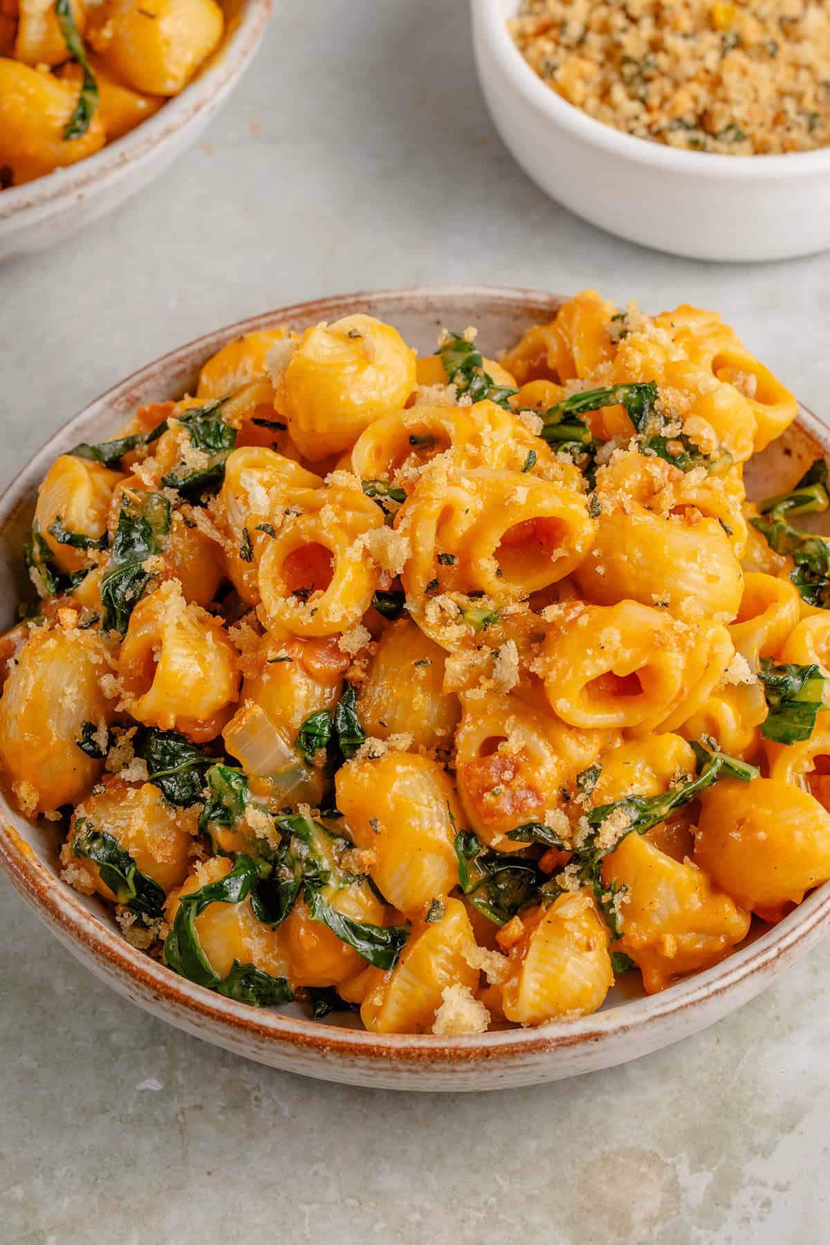 closeup photo of creamy vegan pumpkin mac and cheese with toasted breadcrumbs