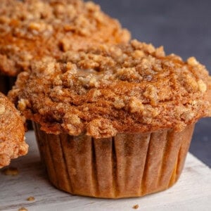 overhead photo of freshly baked pumpkin cream cheese muffins on white board