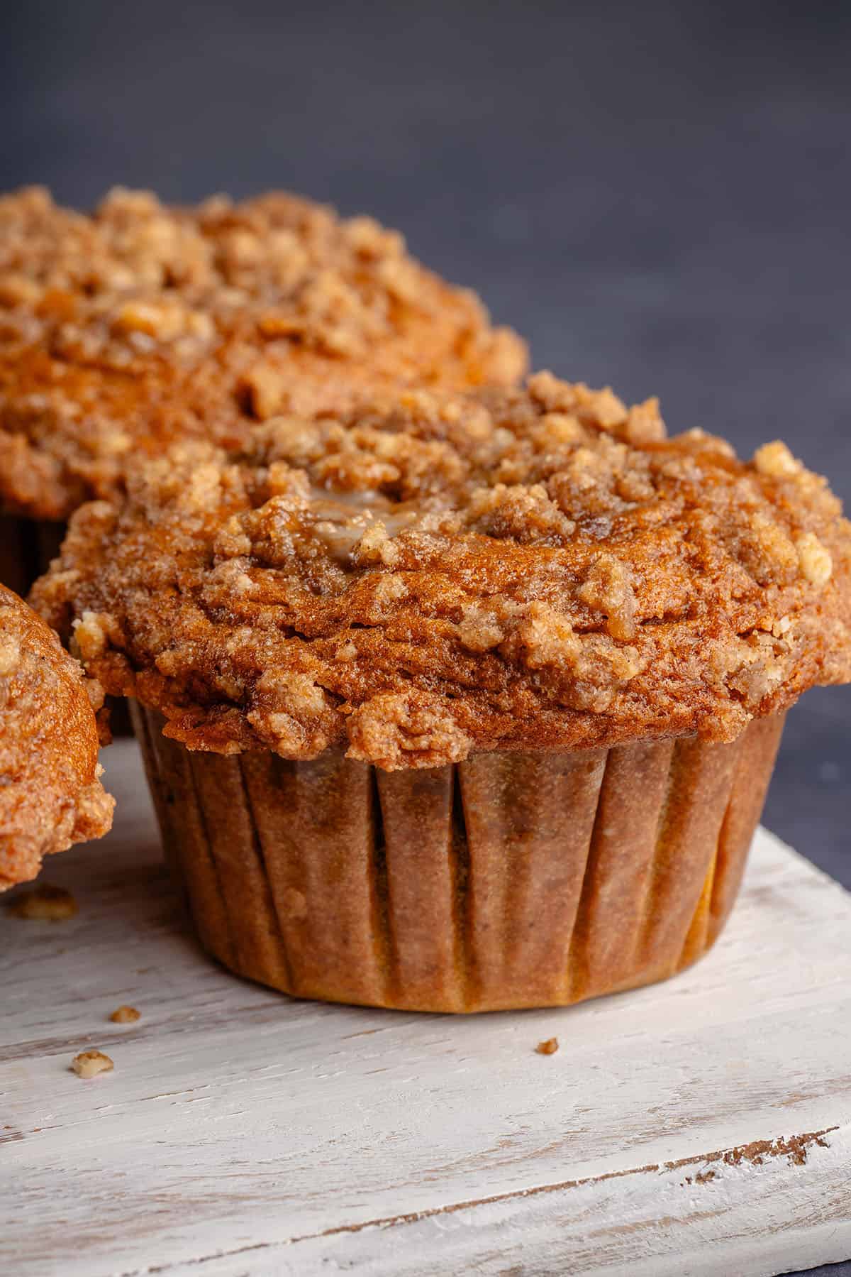 overhead photo of freshly baked pumpkin cream cheese muffins on white board