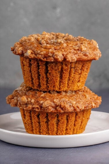 stack of 2 pumpkin cream cheese muffins on white plate