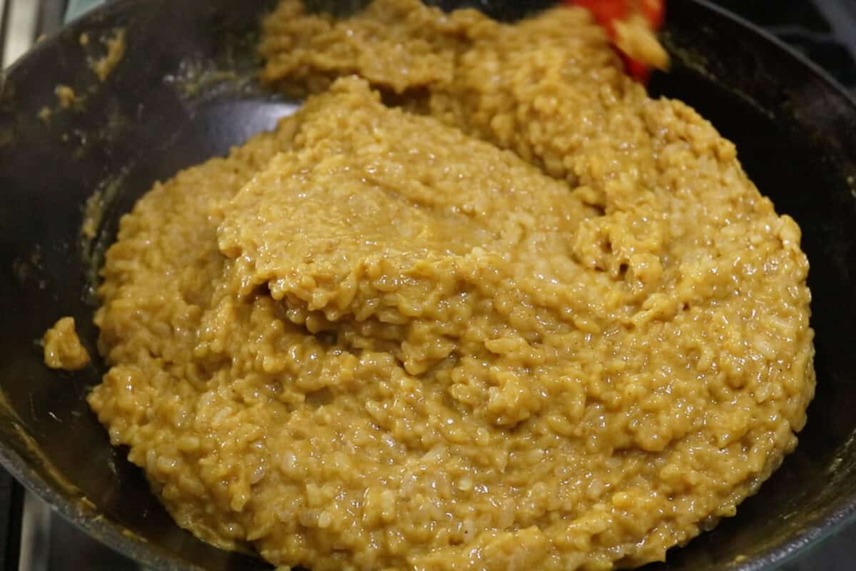 mixing Biko Kalabasa (Pumpkin Biko) in a large wok