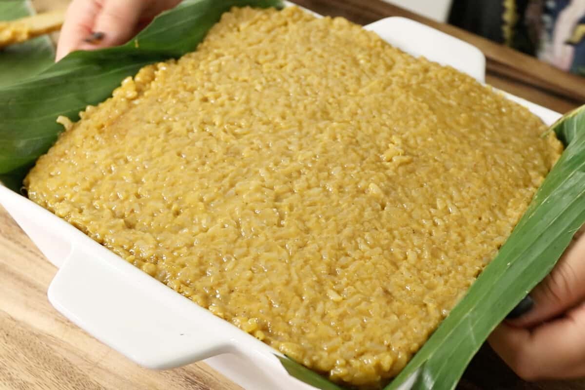 warm Biko Kalabasa (Pumpkin Biko) into pan lined with banana leaves