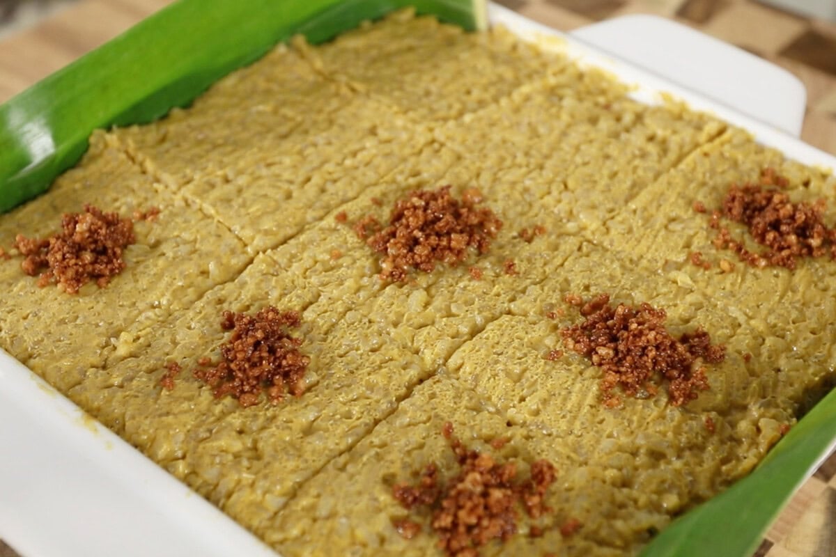 Biko Kalabasa (Pumpkin Biko) with latik in pan lined with banana leaves