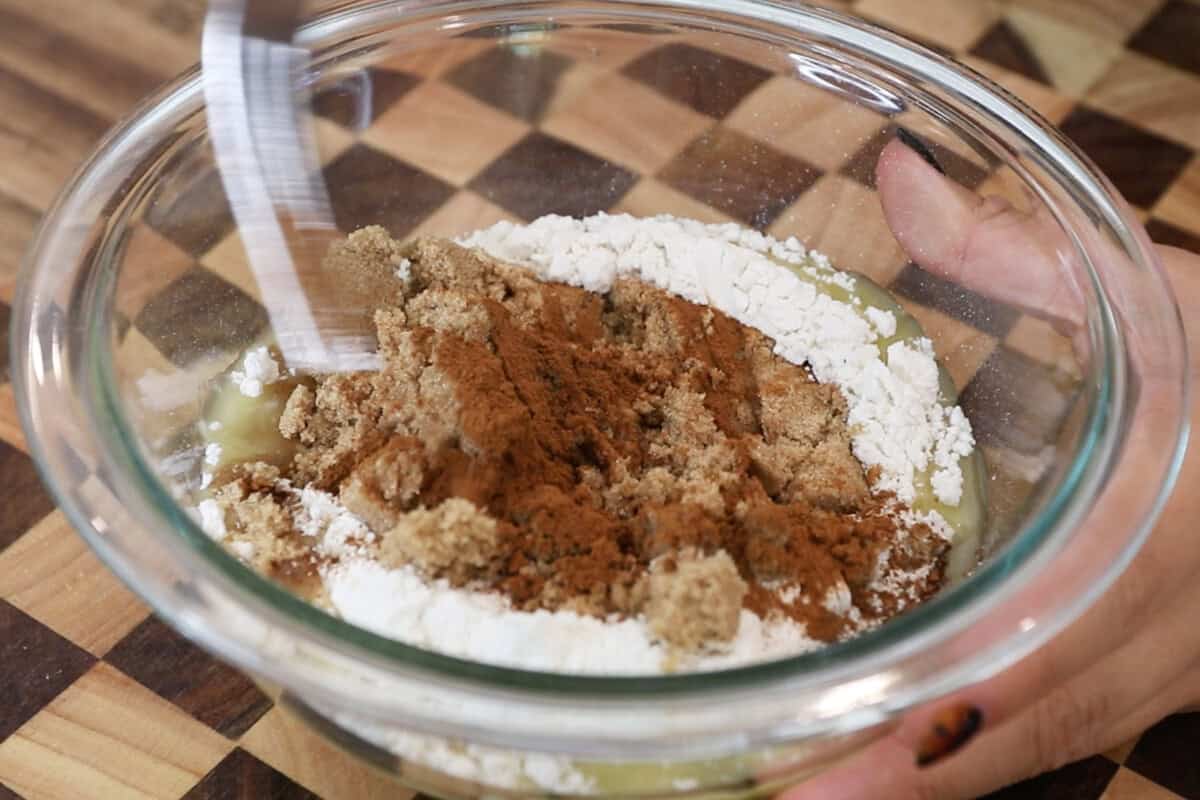 preparing streusel topping in glass bowl for pumpkin cream cheese muffins