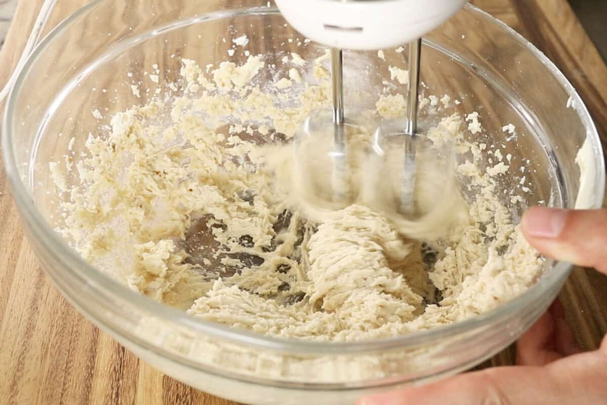 preparing the batter for vegan coffee cake in large glass bowl