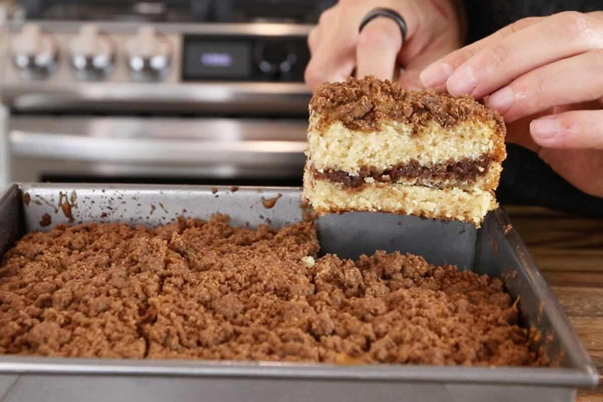 picking up a slice of vegan coffee cake with a spatula