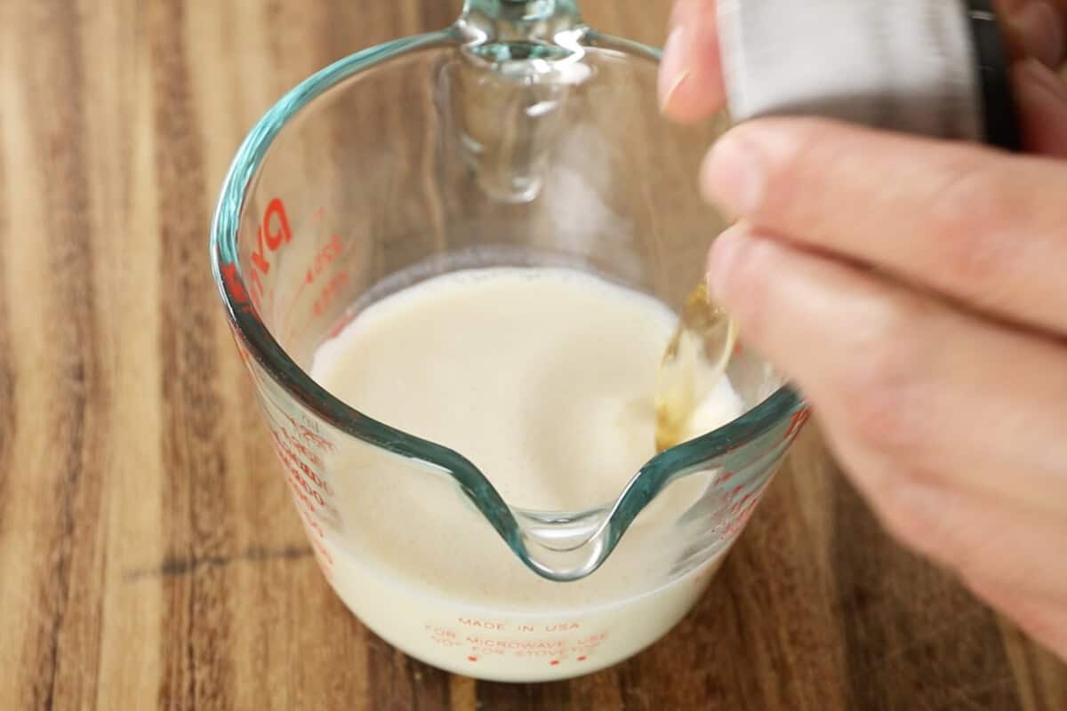 making vegan buttermilk with soy milk and vinegar for coffee cake