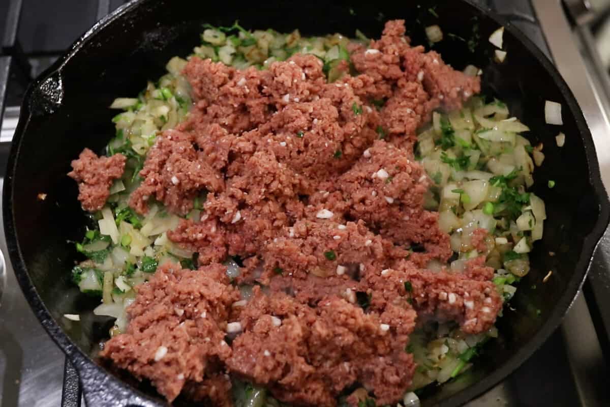 adding vegan ground beef to the skillet