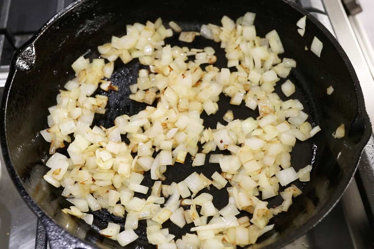 sautéing onions in a cast iron skillet