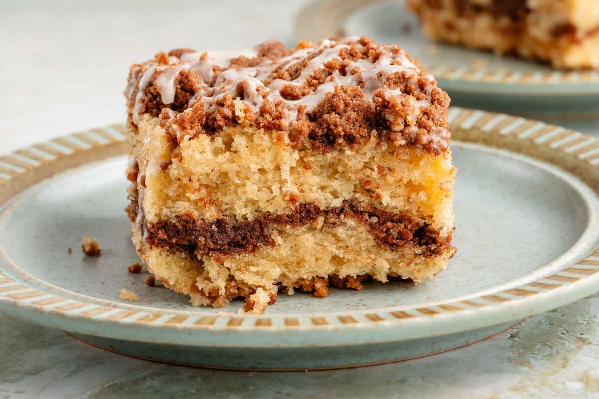 vertical photo of a slice of vegan coffee cake on blue plate