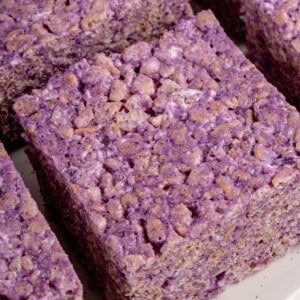 ube rice krispie treats cut into squares onto a white platter