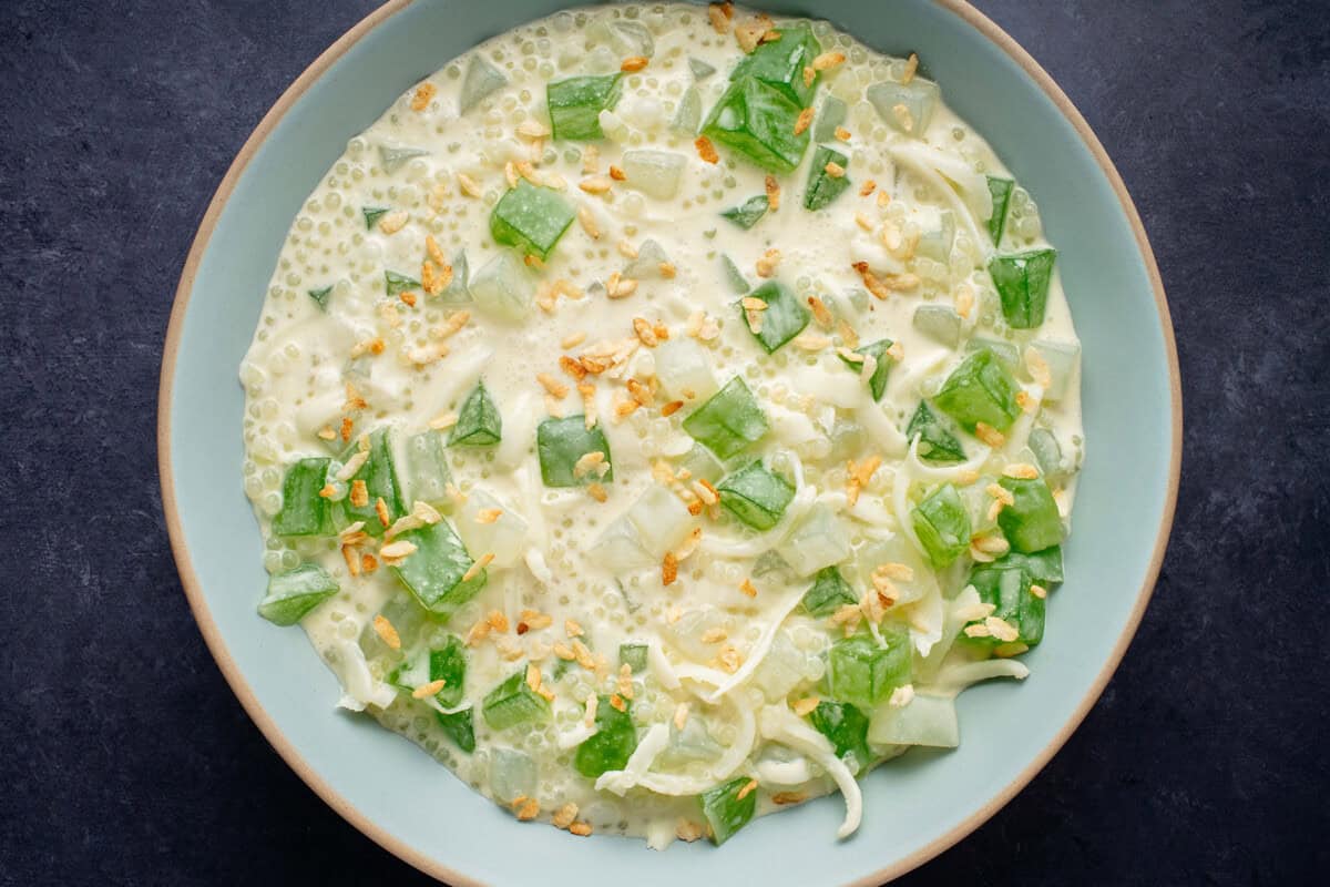 horizontal photo of Filipino Buko Pandan Salad in light blue bowl