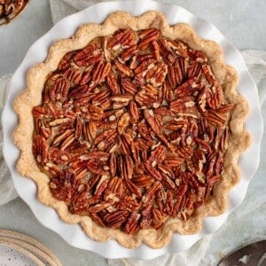 classic vegan pecan pie with a napkin and plates and spatula