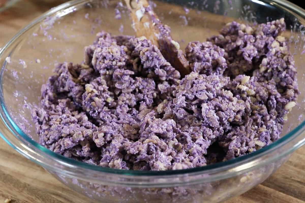 mixing the crispy rice and ube marshmallow mixture together