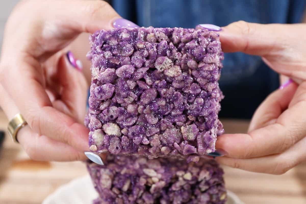 ube rice krispie treats held in hand