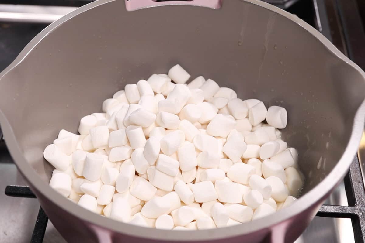 adding marshmallows to the pot