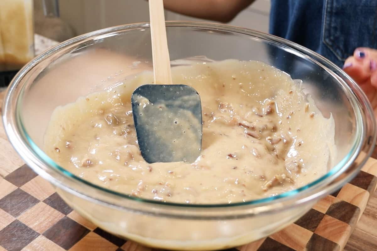 mixing the pecan pie filling in a large bowl