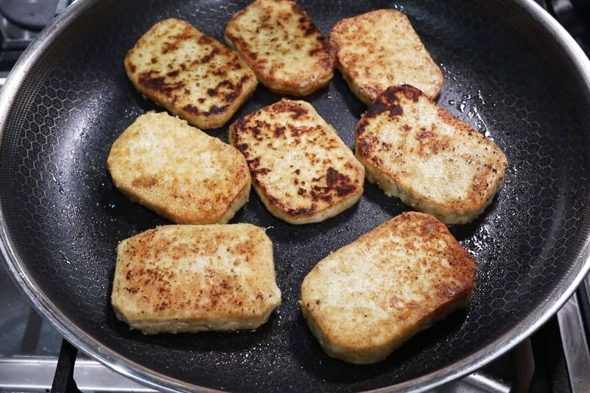 fried tofu slabs in skillet