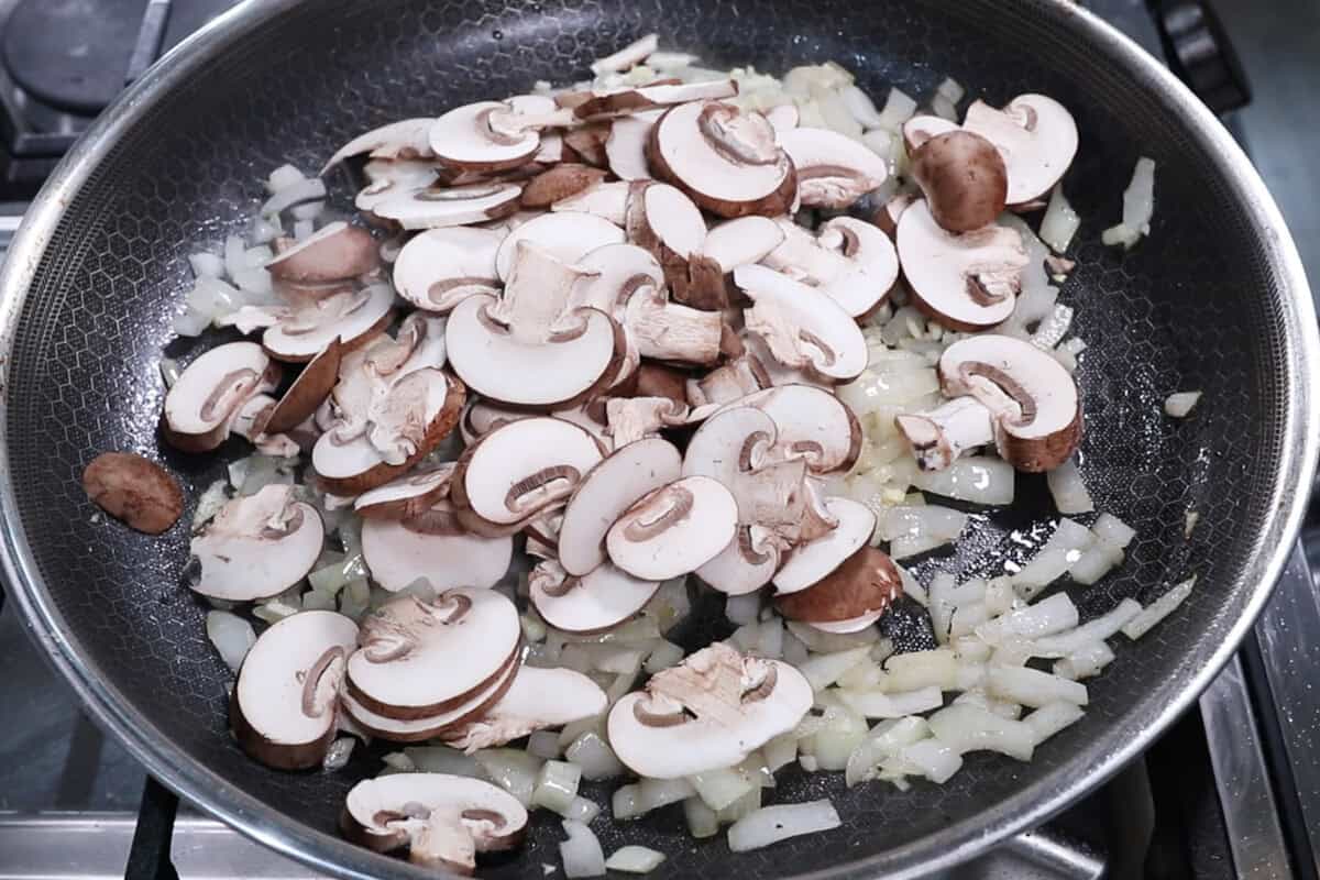 adding mushrooms to the skillet