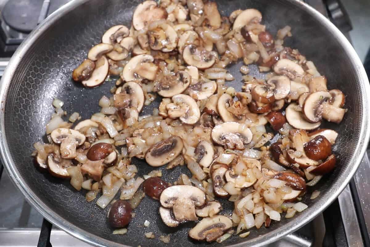 cooked mushrooms and onions in a skillet