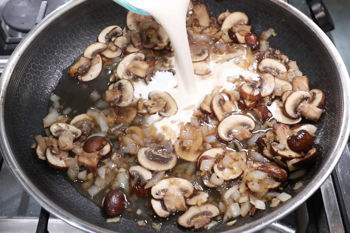 adding heavy cream to the pan