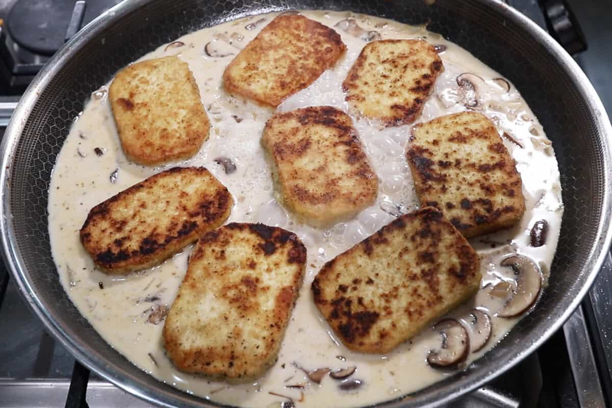 adding the tofu to the skillet