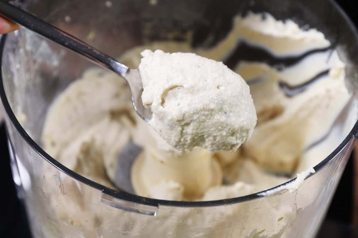 scoop of tofu ricotta out of the food processor