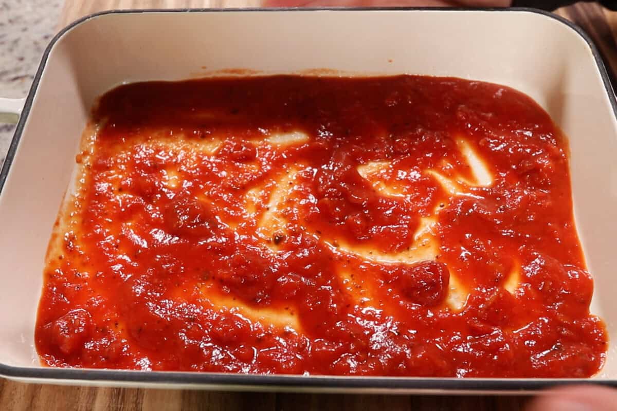 marinara on the bottom of a baking dish