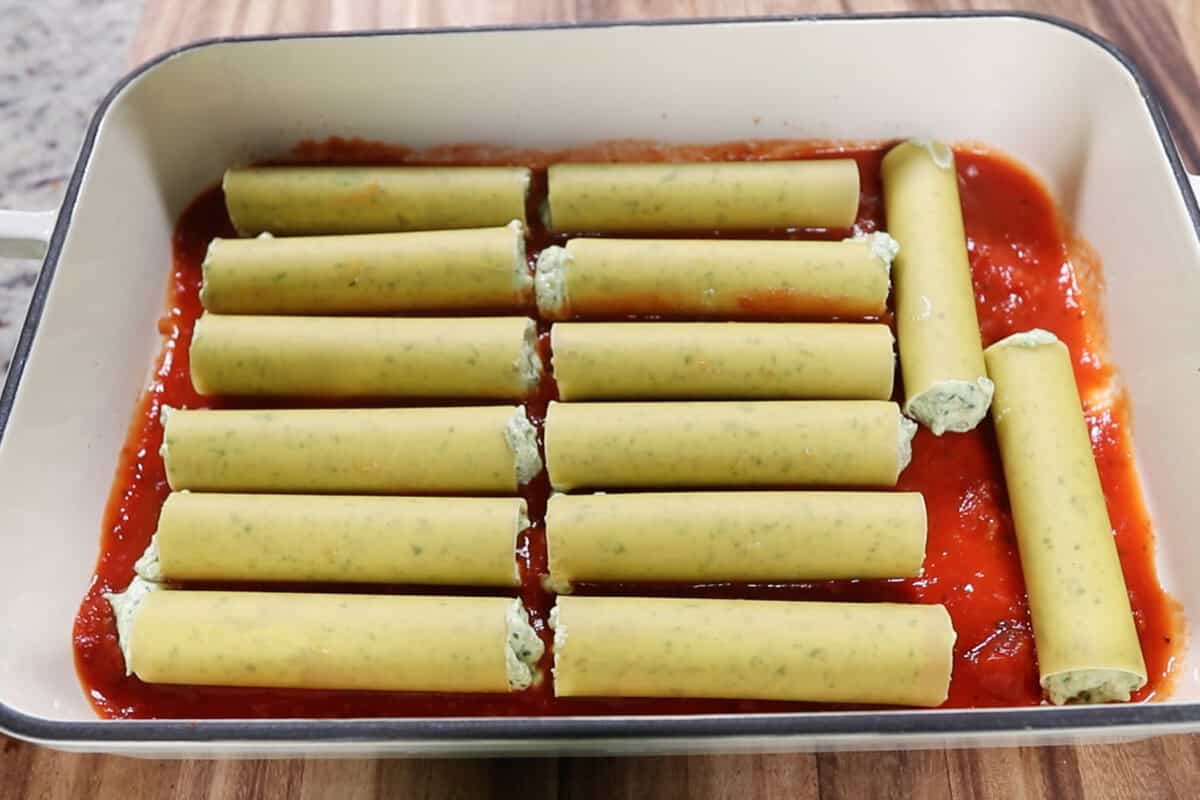 filled manicotti noodles in a baking dish