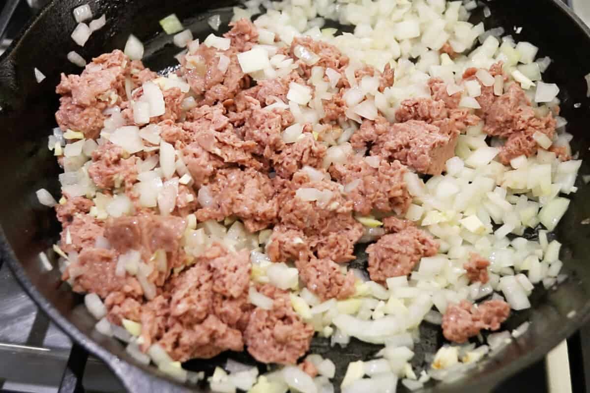 adding vegan beef to the skillet