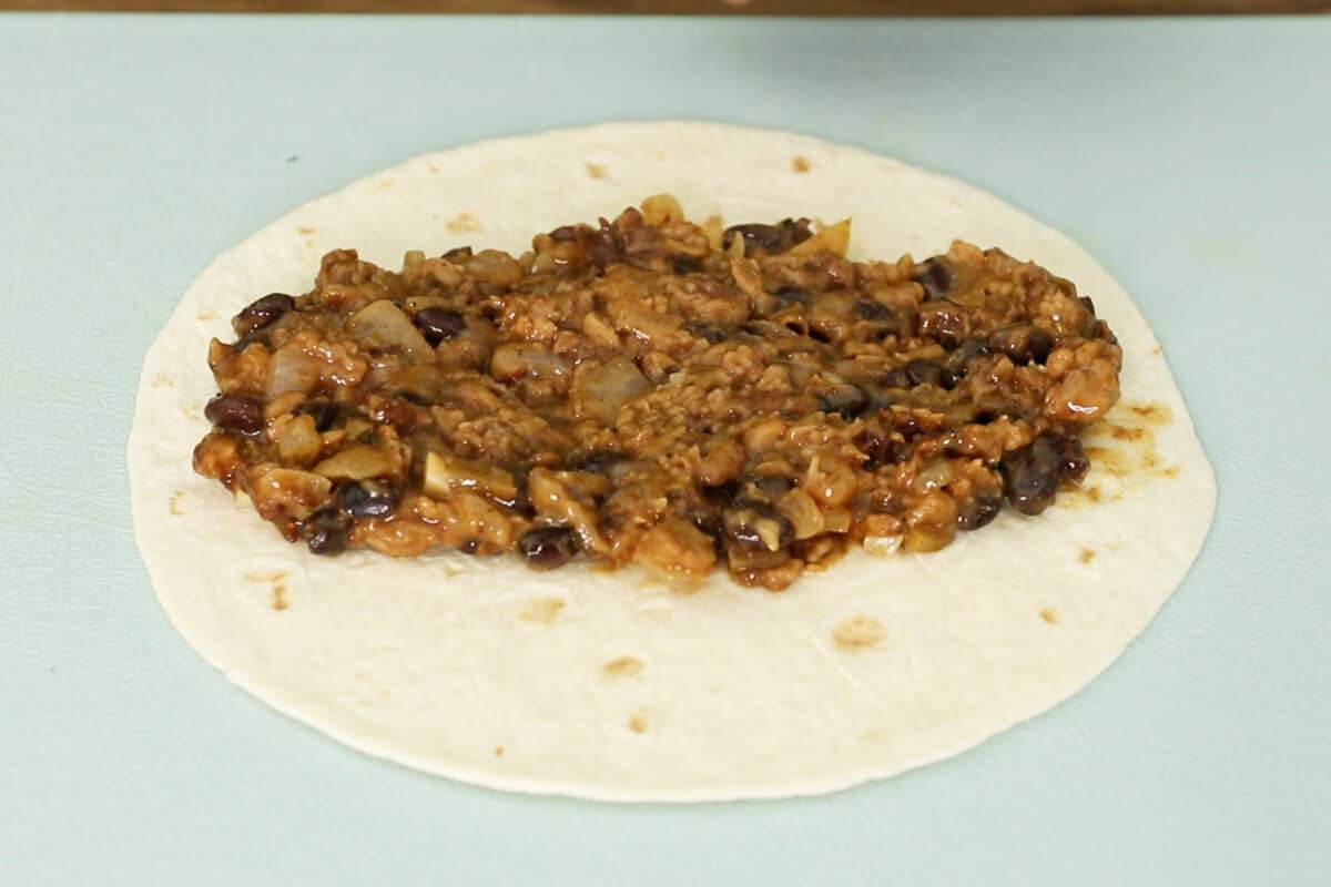 adding filling to tortillas