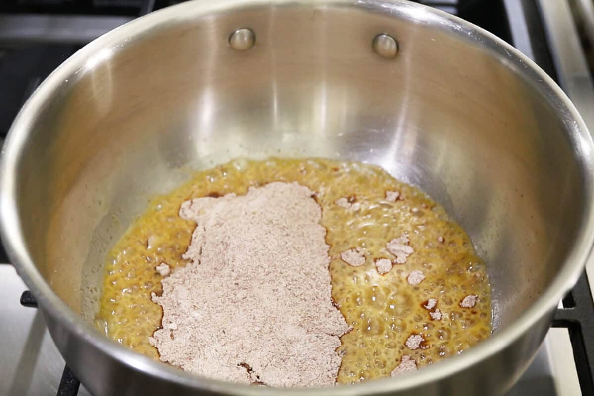 adding the enchilada sauce seasoning to the oiled pot