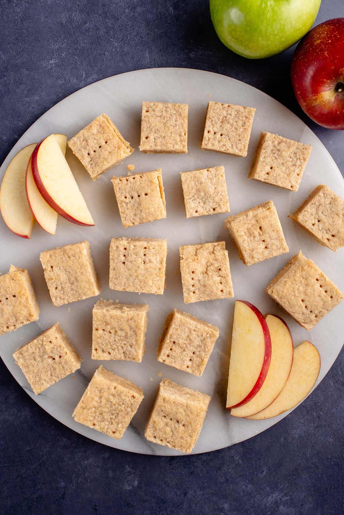 sliced shortbread on a white plater with sliced apples