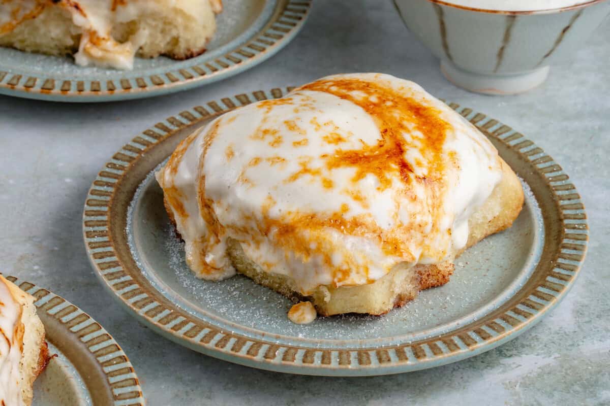 Creme Brûlée cinnamon rolls on a blue plate