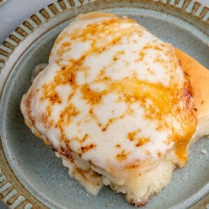 overhead of vegan Creme Brûlée cinnamon roll on blue plate