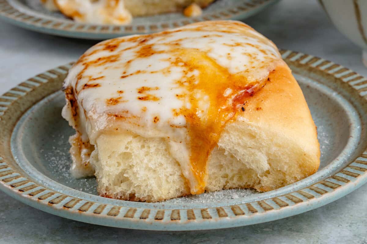 Creme Brûlée cinnamon roll on a blue plate