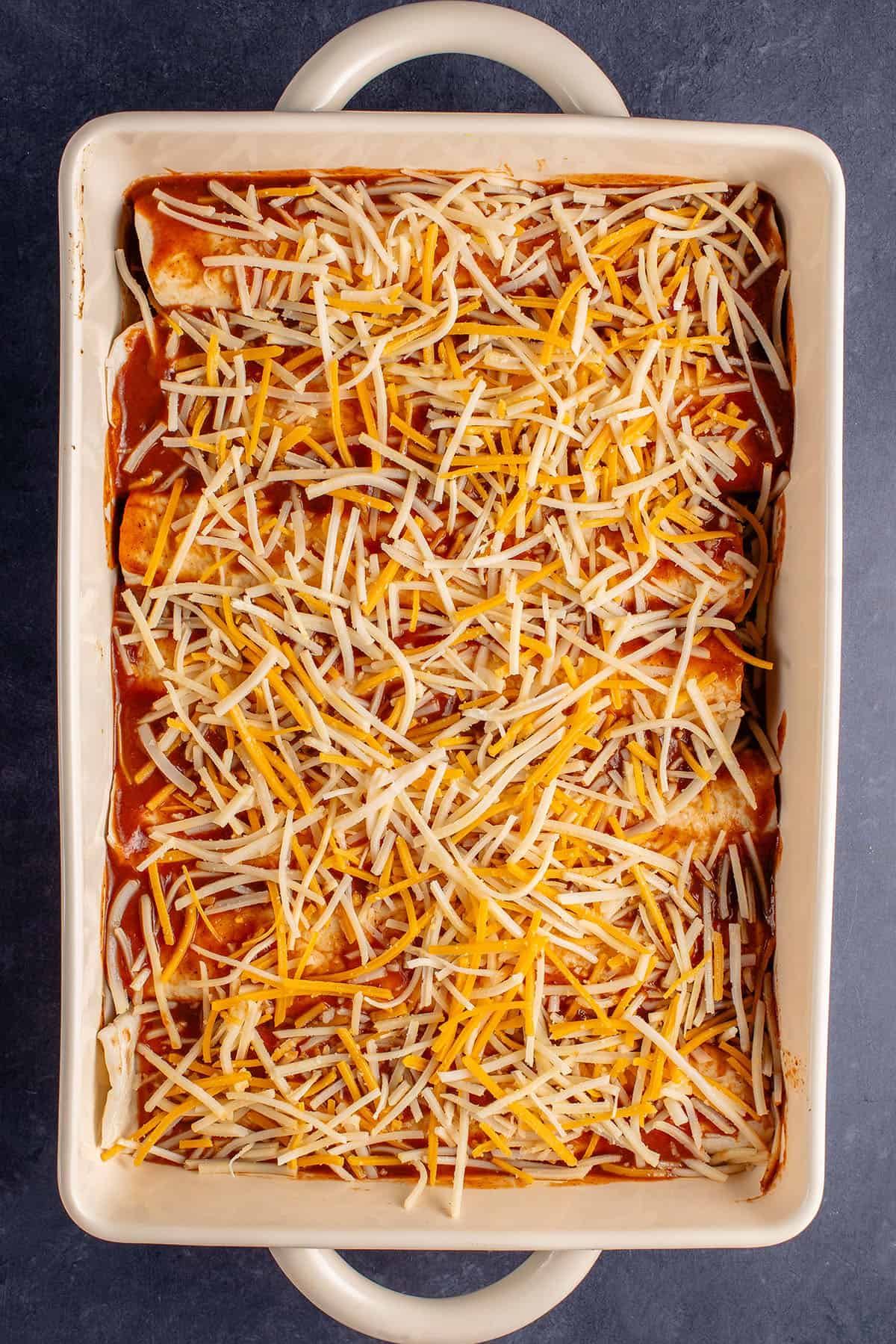 enchiladas in baking dish before being baked