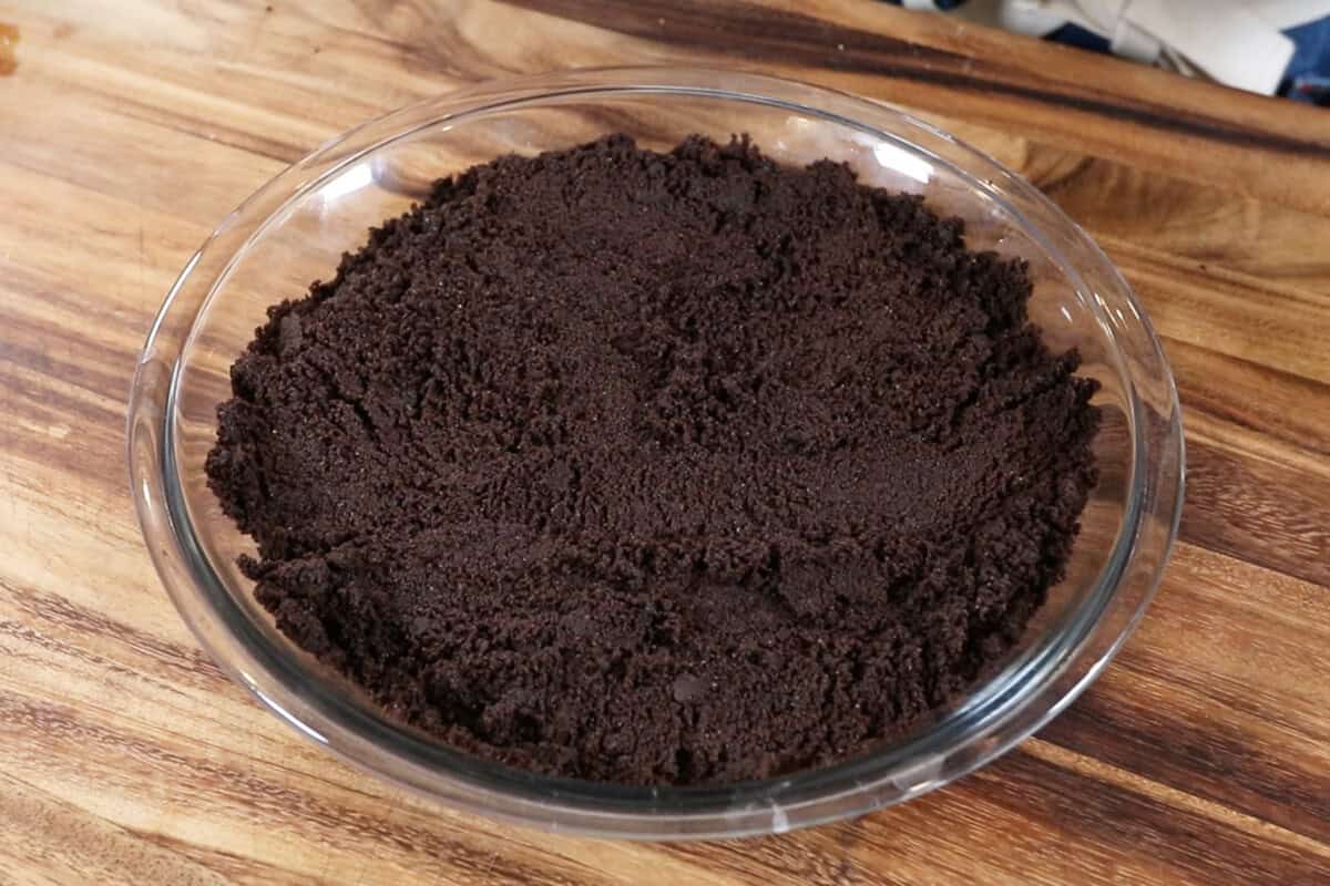 oreo cookie crumbs in bottom of a pie dish