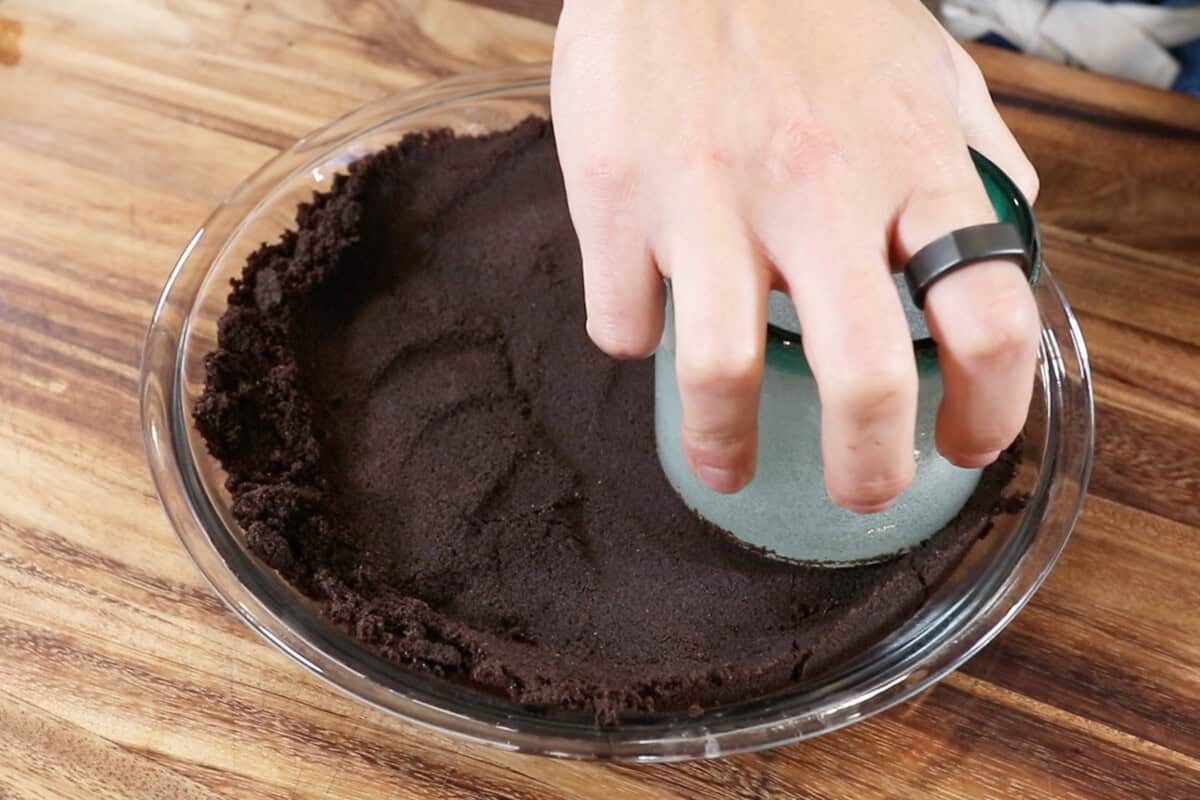 pressing down crust with a cup