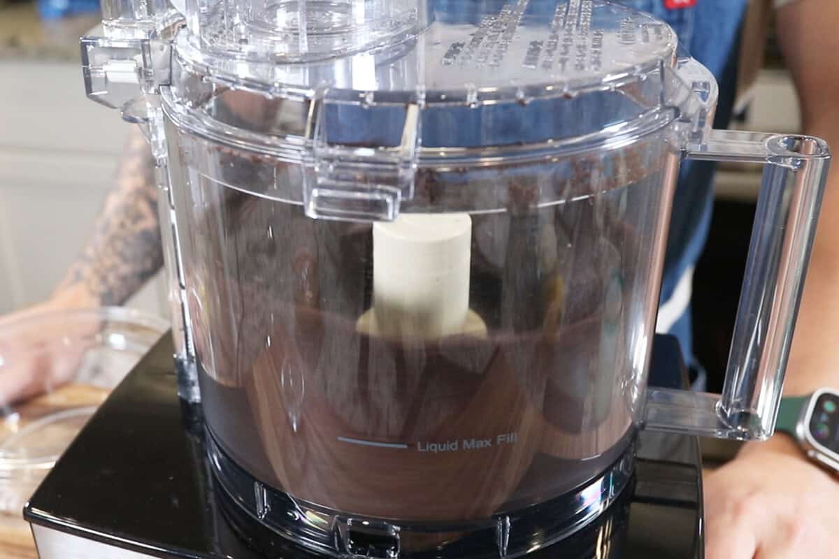 pulverized oreo cookies being processed in a food processor