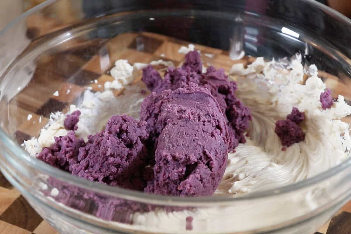 adding mashed ube to a large bowl