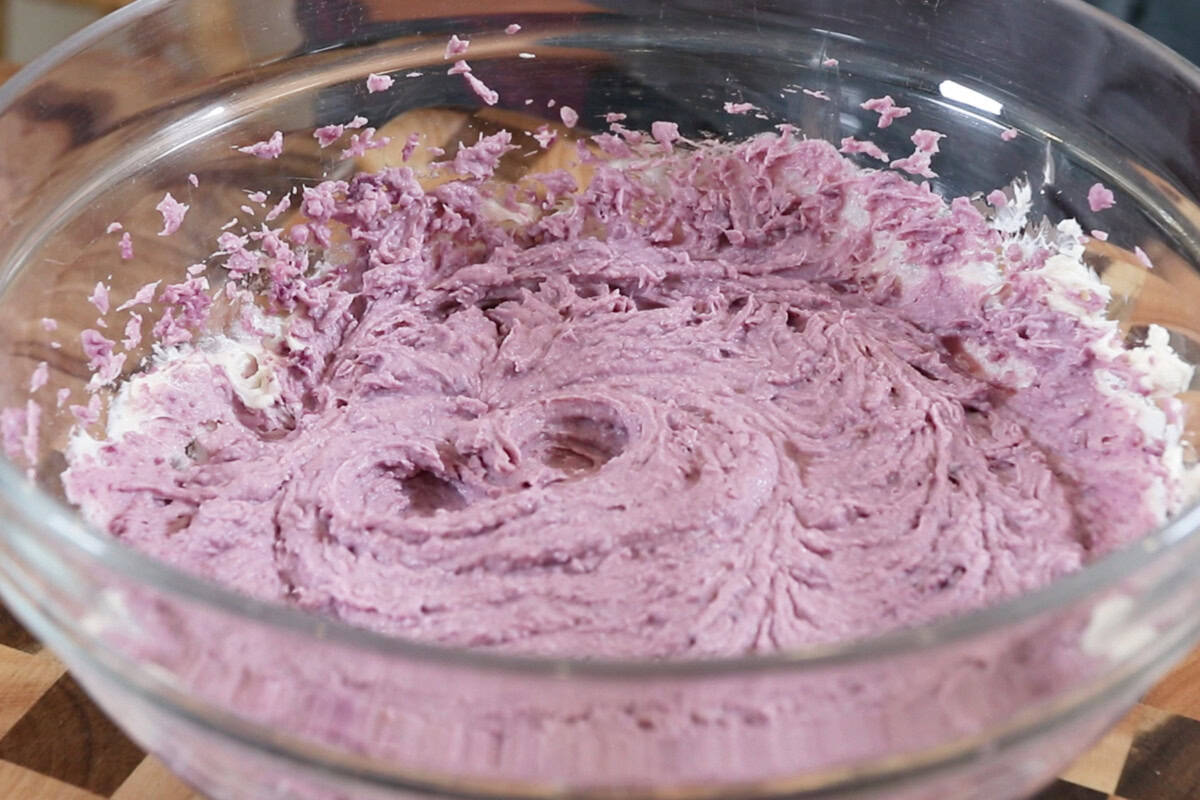 whipped cream cheese and mashed ube in a large bowl