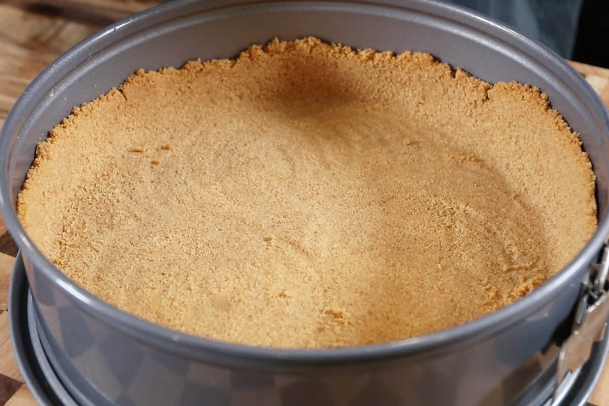 finished graham cracker crust in a springform pan